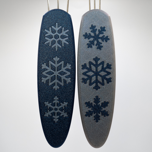 Falling Snow Cordsmiths. The Original is a navy handle with Mercury snowflakes and the Mini has the colors inverted and slightly different snowflakes.